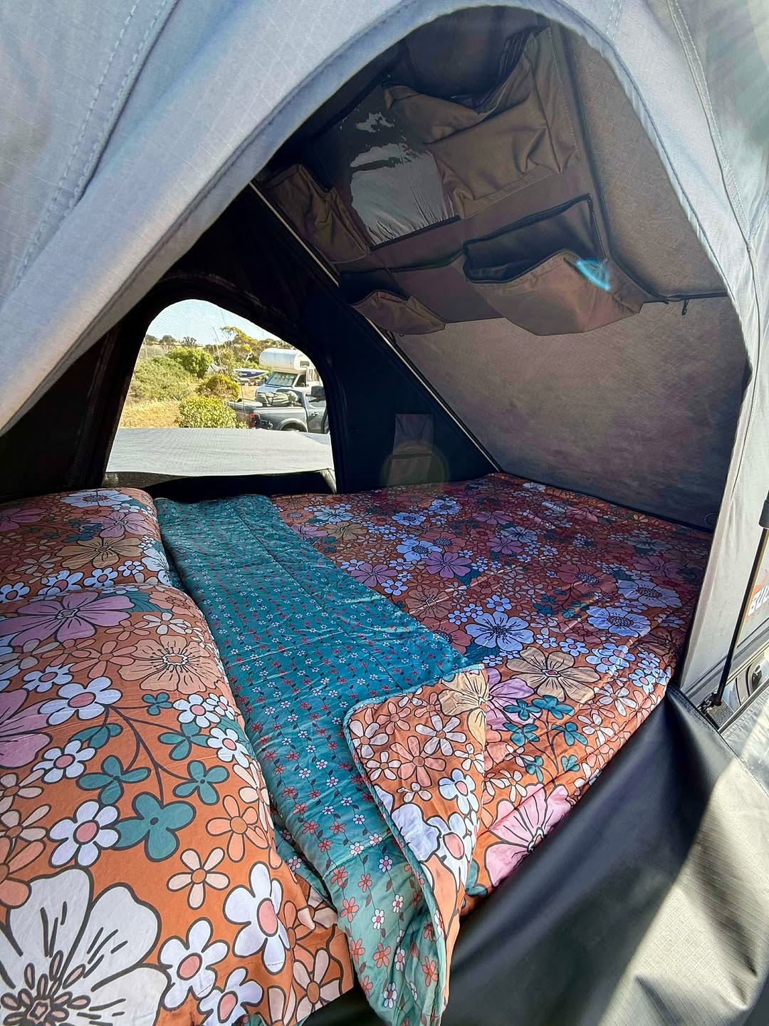 Roof top tent dressed in vintage 70s floral and teal Zipluxe bed set